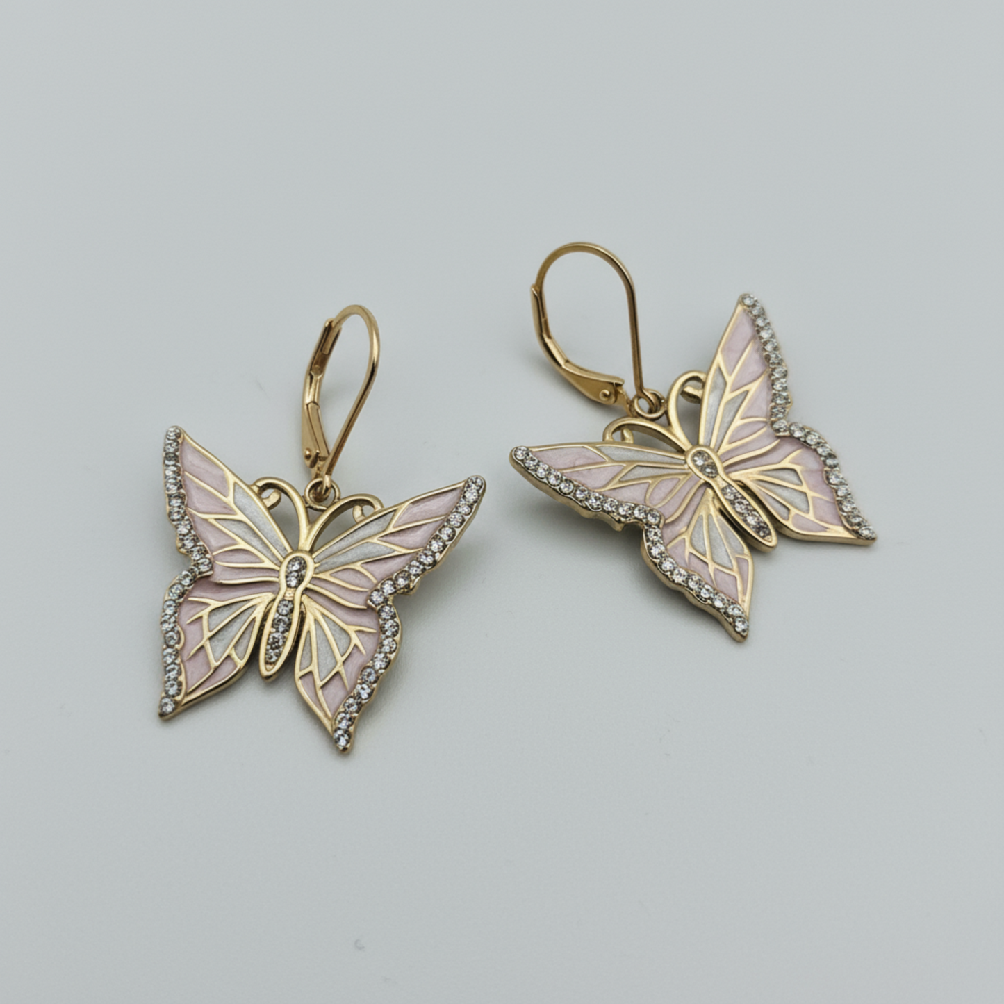 Butterfly earrings with gold and pink design on a white background