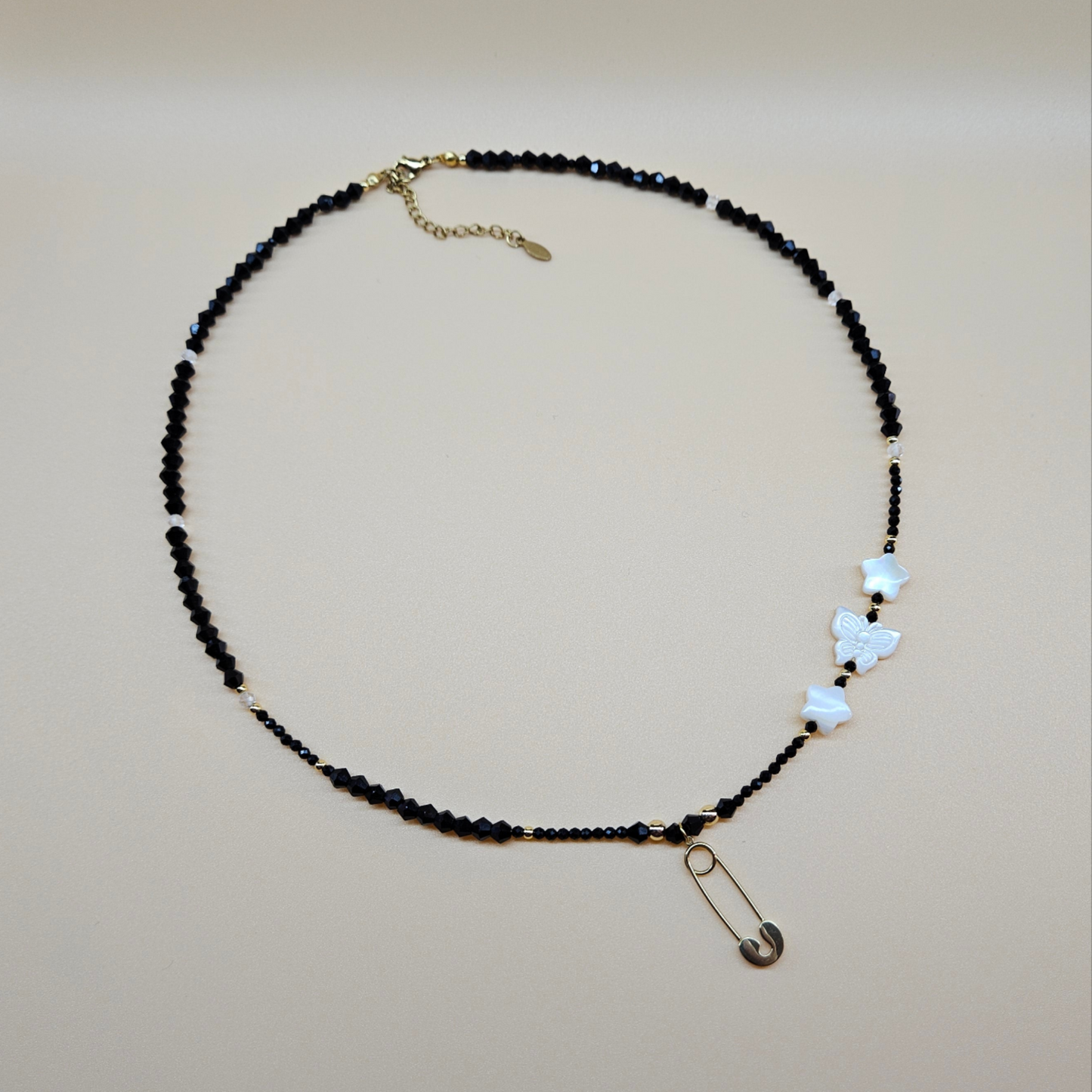 Black Glass Beaded Necklace with Gold-Plated Safety Pin Pendant Featuring Butterfly and Star Shaped Beads