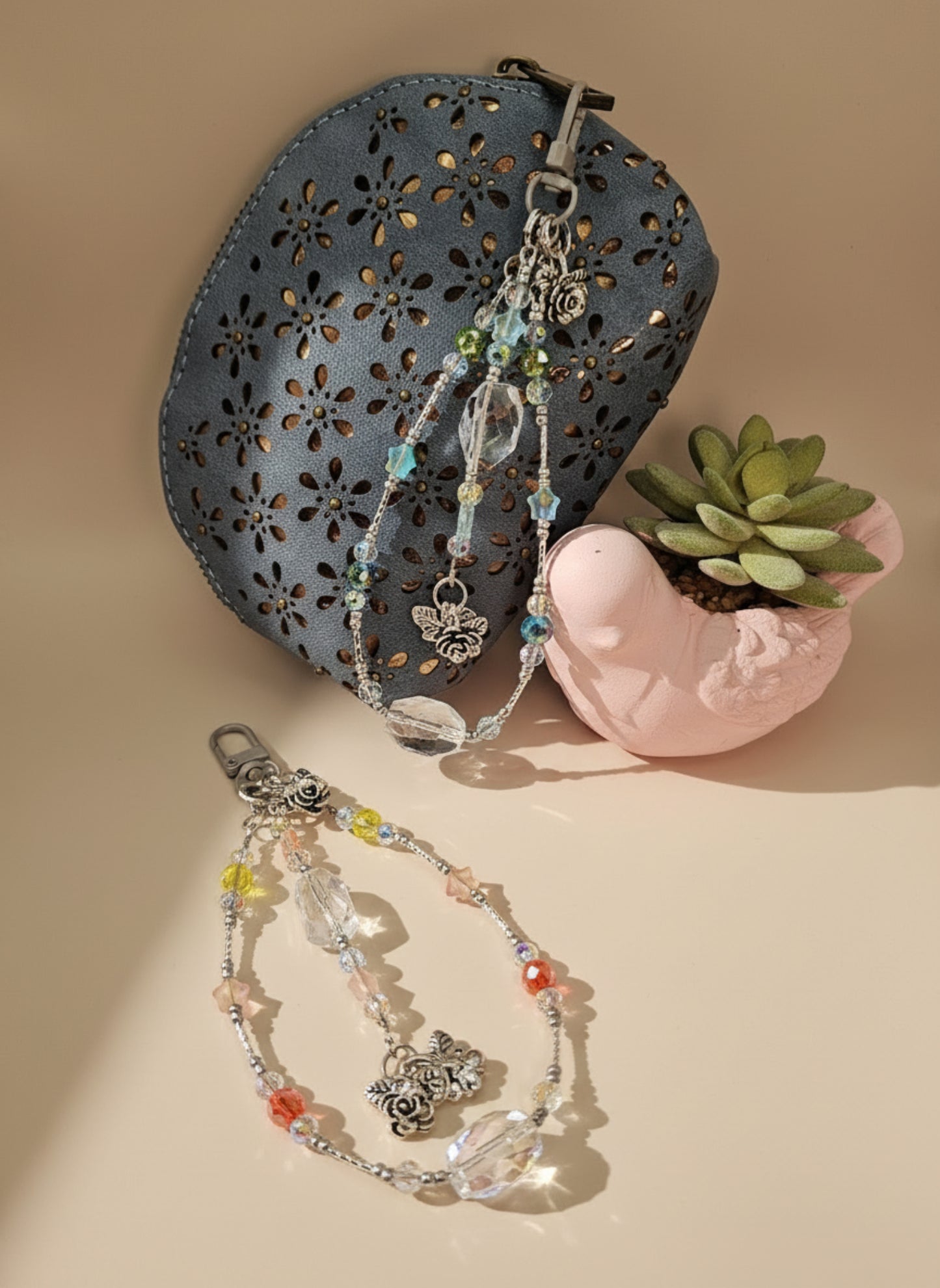 Small blue purse with decorative items on a light gray surface